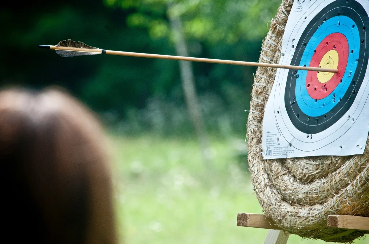 An arrow in a colourful outdoor archery target